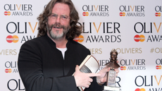 Greg Doran at the Olivier Awards holding his award 