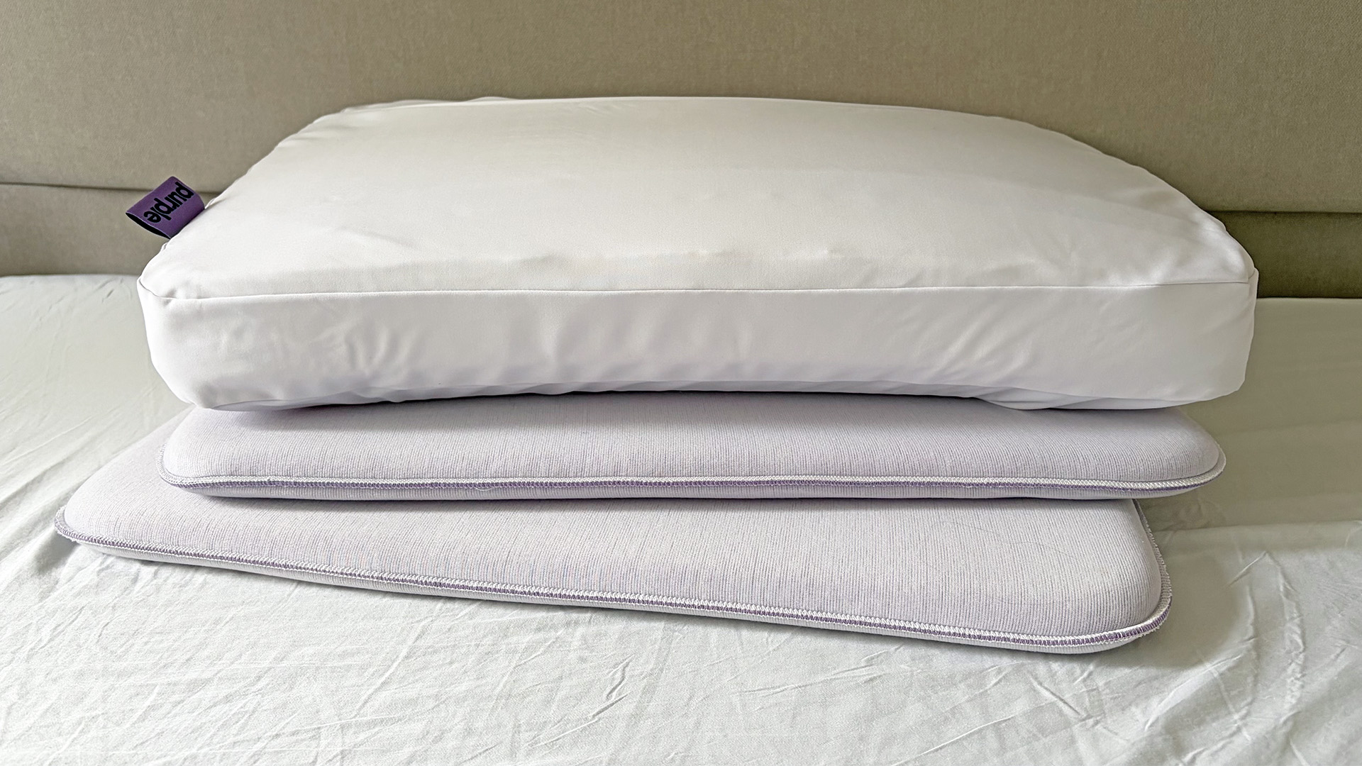 The Purple DreamLayer Pillow sitting on its booster layers, in our reviewer's bedroom