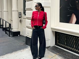 Influencer wearing a red jacket and black jeans in NYC