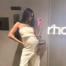 Hailey Bieber posts an Instagram story where she wears a strapless cream maternity suit an Hermes bag and white flats