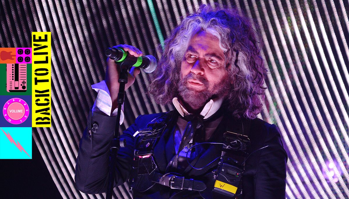 A photograph of Wayne Coyne of the Flaming Lips performing live on stage