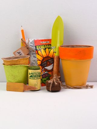 Kids garden set with yellow terracotta pot, mini spade, seed pots and notebook and pen