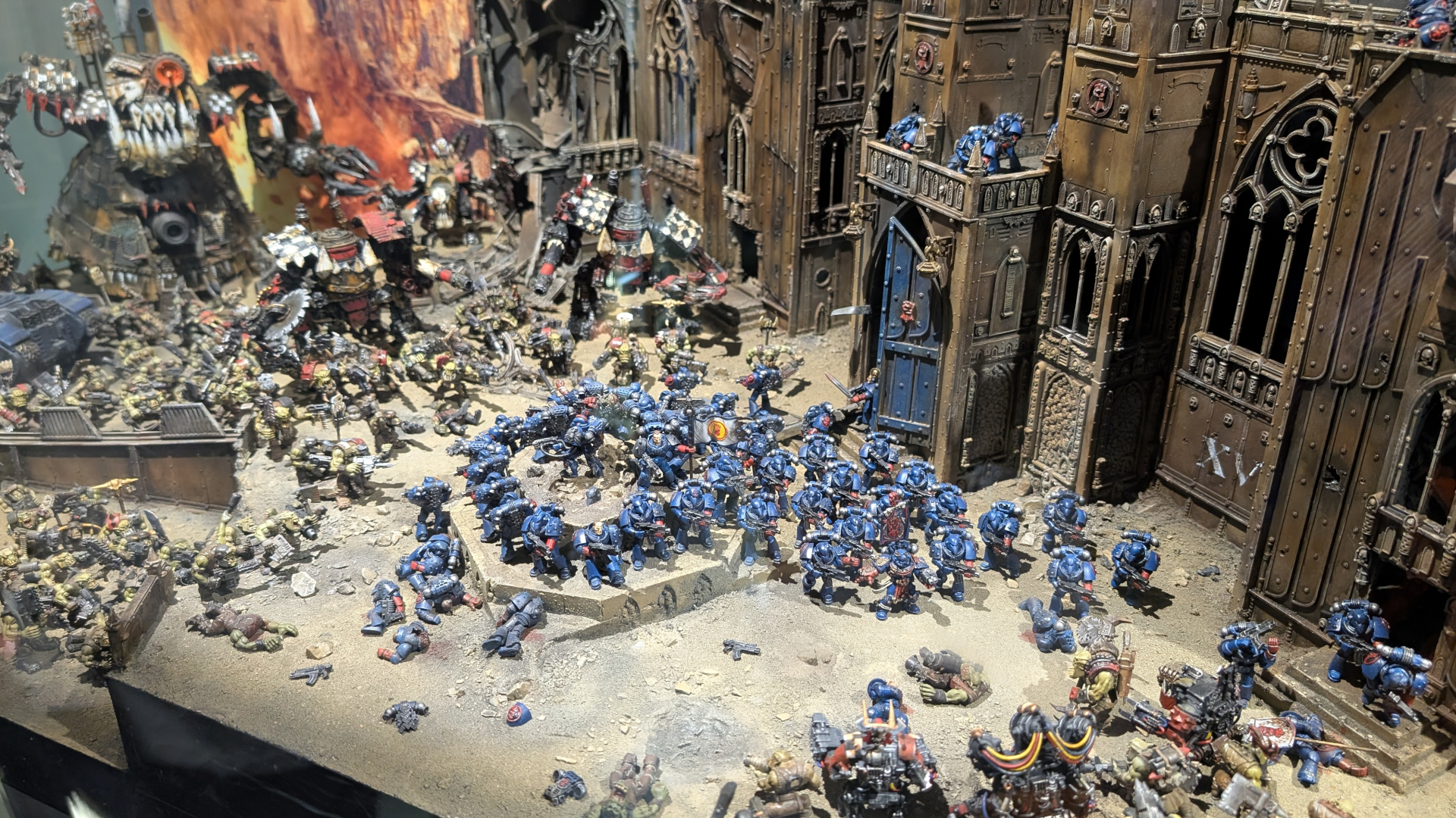 A group of Space Marines gets surrounded by Orks on a Warhammer 40,000 battlefield