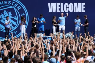 Erling Haaland is presented to the Manchester City fans alongside Julian Alvarez and Stefan Ortega at a special event in July 2022.