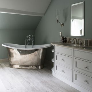 main bathroom with metallic bathtub and wooden flooring