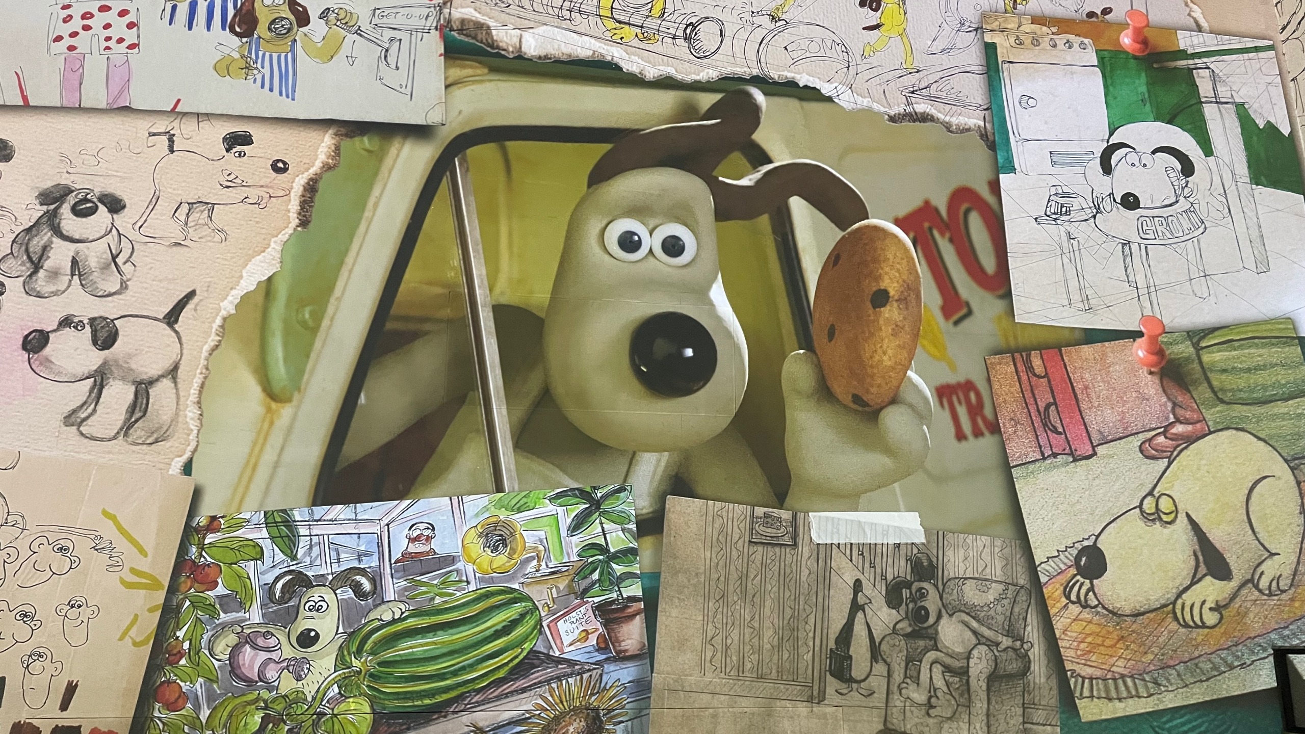Gromit peeking out from behind sketches featuring himself, as seen in the Larger Than Life: The Aardman Story exhibition at Lightroom, King's Cross.