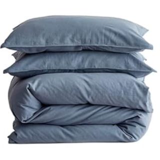 stack of blue bedding on a white background