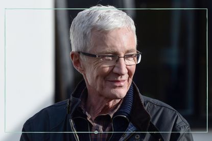 an extreme close up of Paul O'Grady smiling and posing for the camera