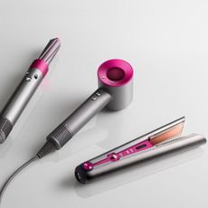 black friday dyson deals - the supersonic hair dryer, airwrap and corrale straighteners on a flat surface