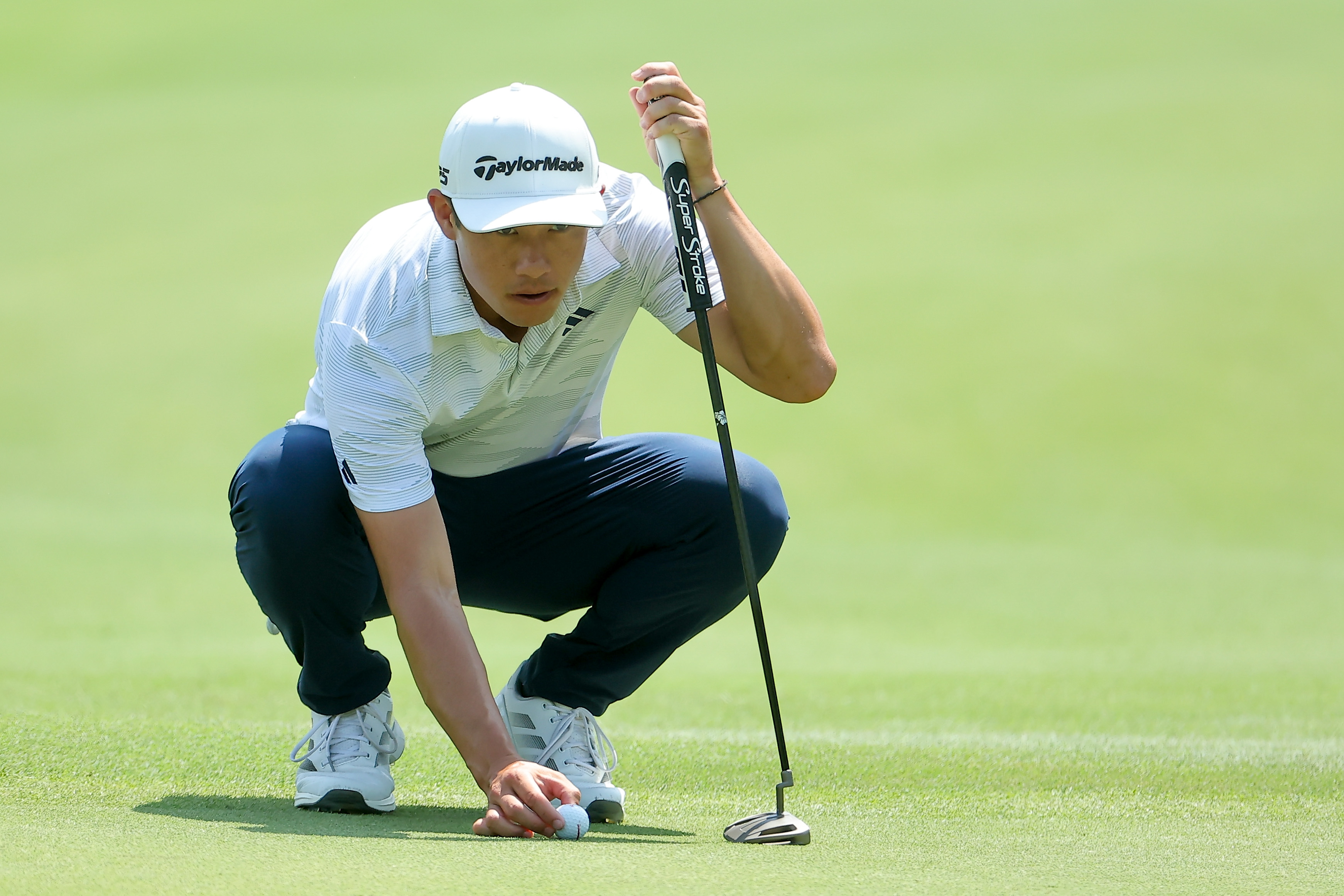 Collin Morikawa lines up a putt
