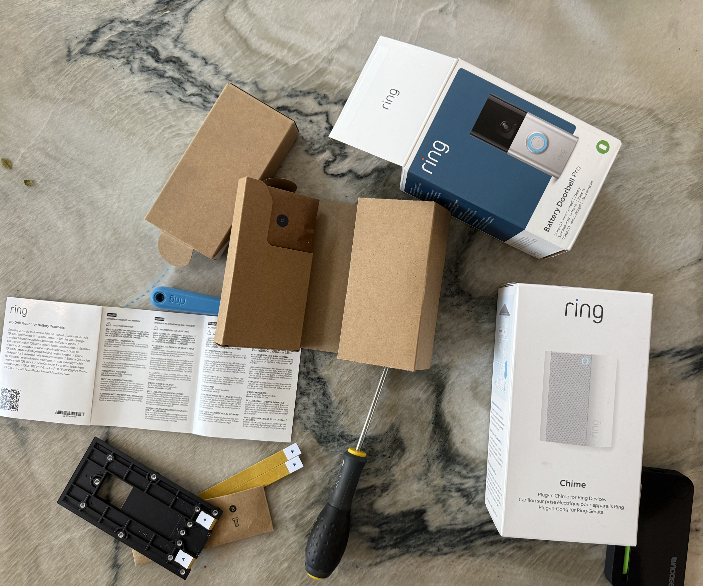Ring video doorbell boxes on worktop along with screwdriver and instructions