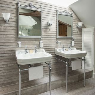 bathroom with wooden finish which contains squared mirrors and white wash basins