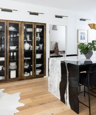 A kitchen with a hidden pantry door disguised by paneling