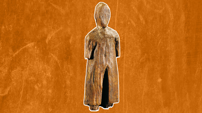 a wooden human figurine on an orange background