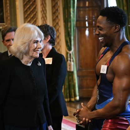 Queen Camilla meets one of the Gladiators