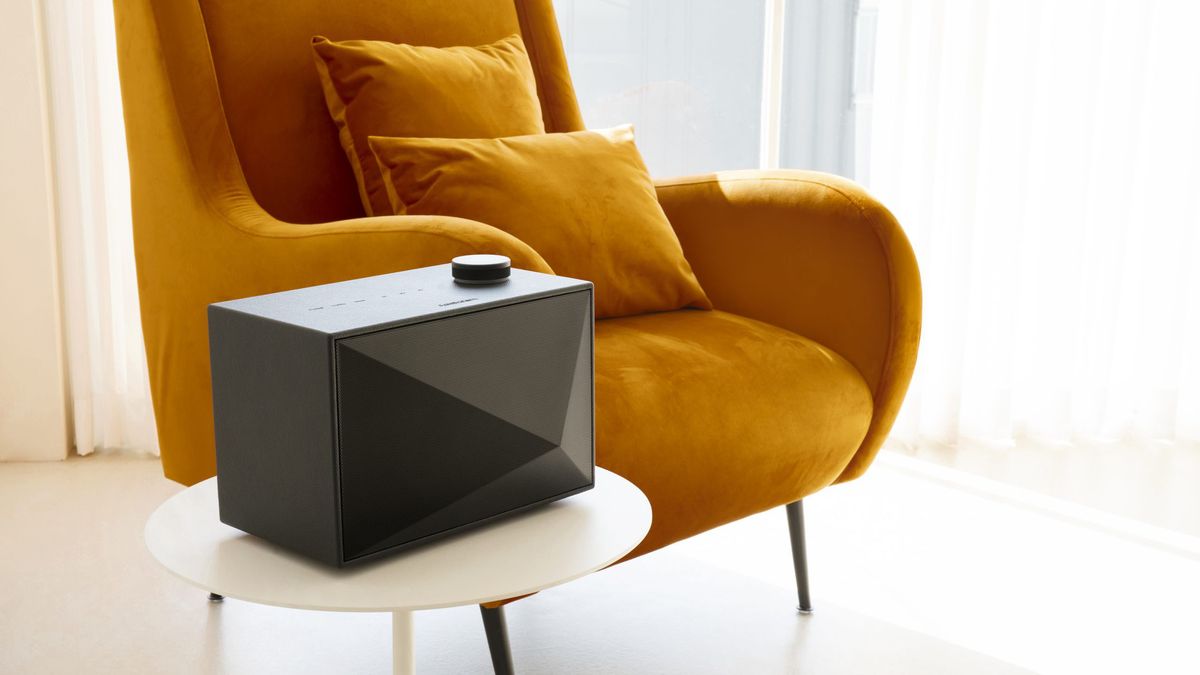 a bluetooth speaker next to an armchair