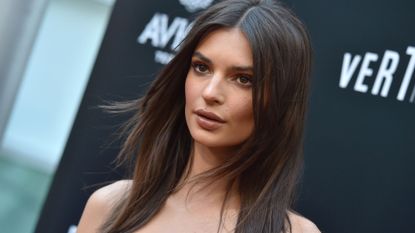 Emily Ratajkowski at a film premier, looking forwards with shoulder length hair