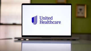 Logo and branding of UnitedHealth, parent company of Change Healthcare, pictured on a laptop screen placed on a desk.