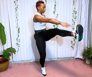 Personal trainer Elethia Gay performs a standing toe reach