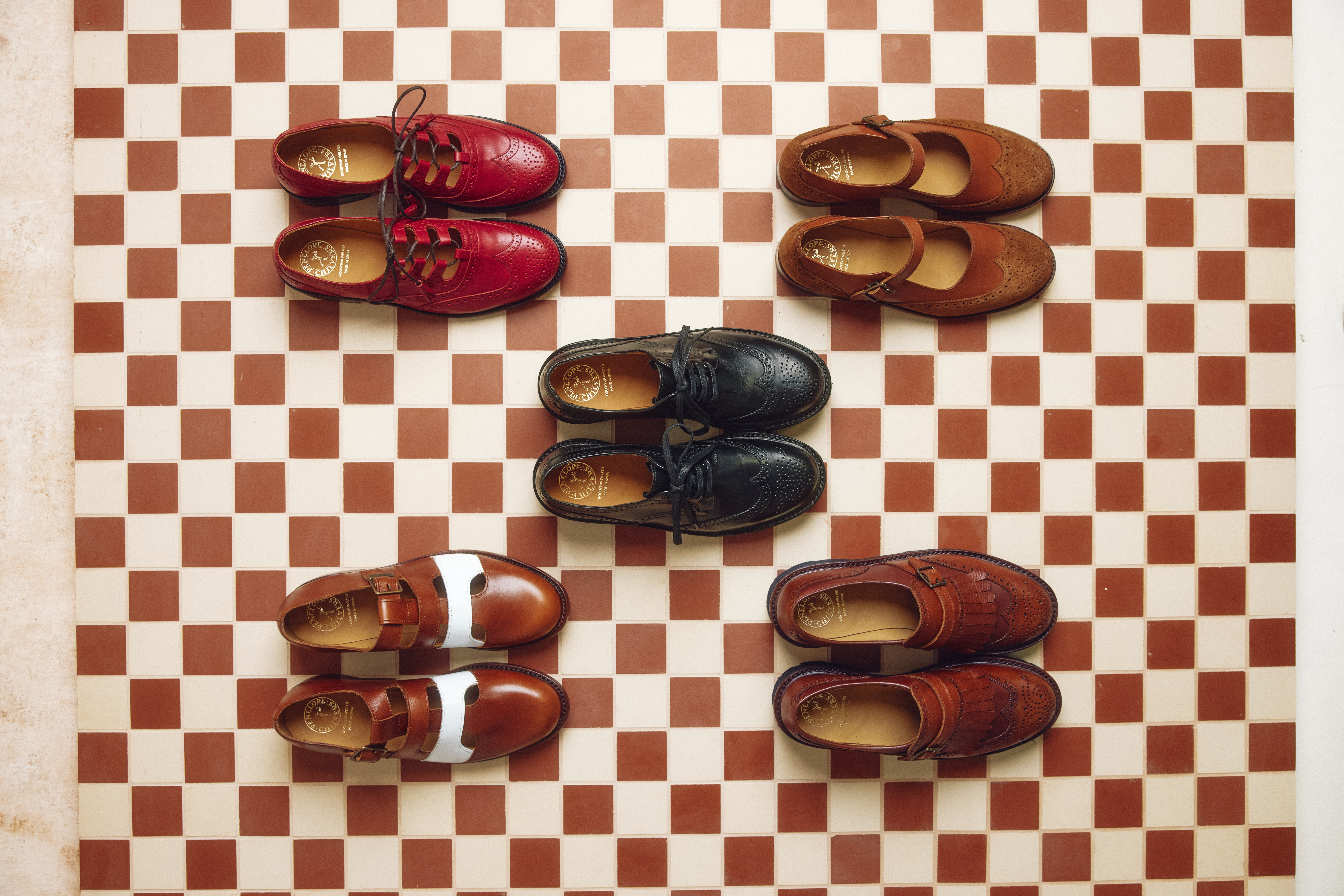 Aerial of Penelope Chilvers shoes on a checkerboard floor