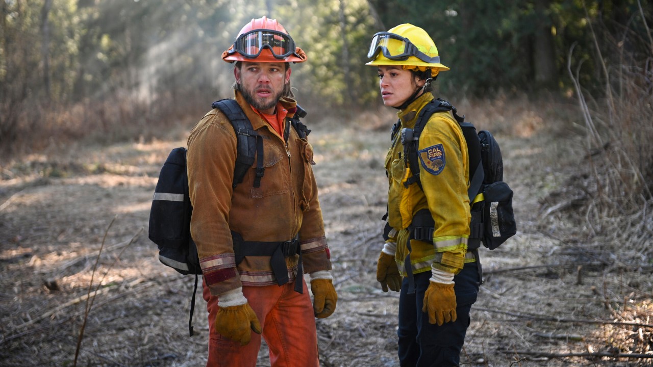 Bode and Gabriela in their fire gear looking forward on Fire Country.