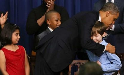 On Jan. 16, President Obama hugs children who wrote letters to the White House about gun violence.