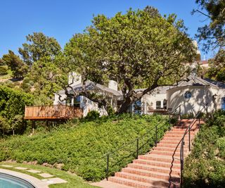 white home exterior with steps to pool