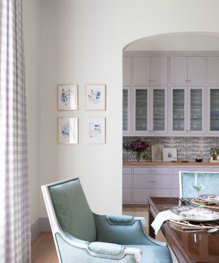 Open plan lavender kitchen with dining area
