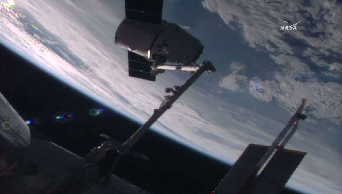 A robotic arm at the International Space Station captures an unmanned Dragon space capsule as it delivered supplies, including a DNA sequencer, to the outpost&#039;s crew on July 20, 2016.