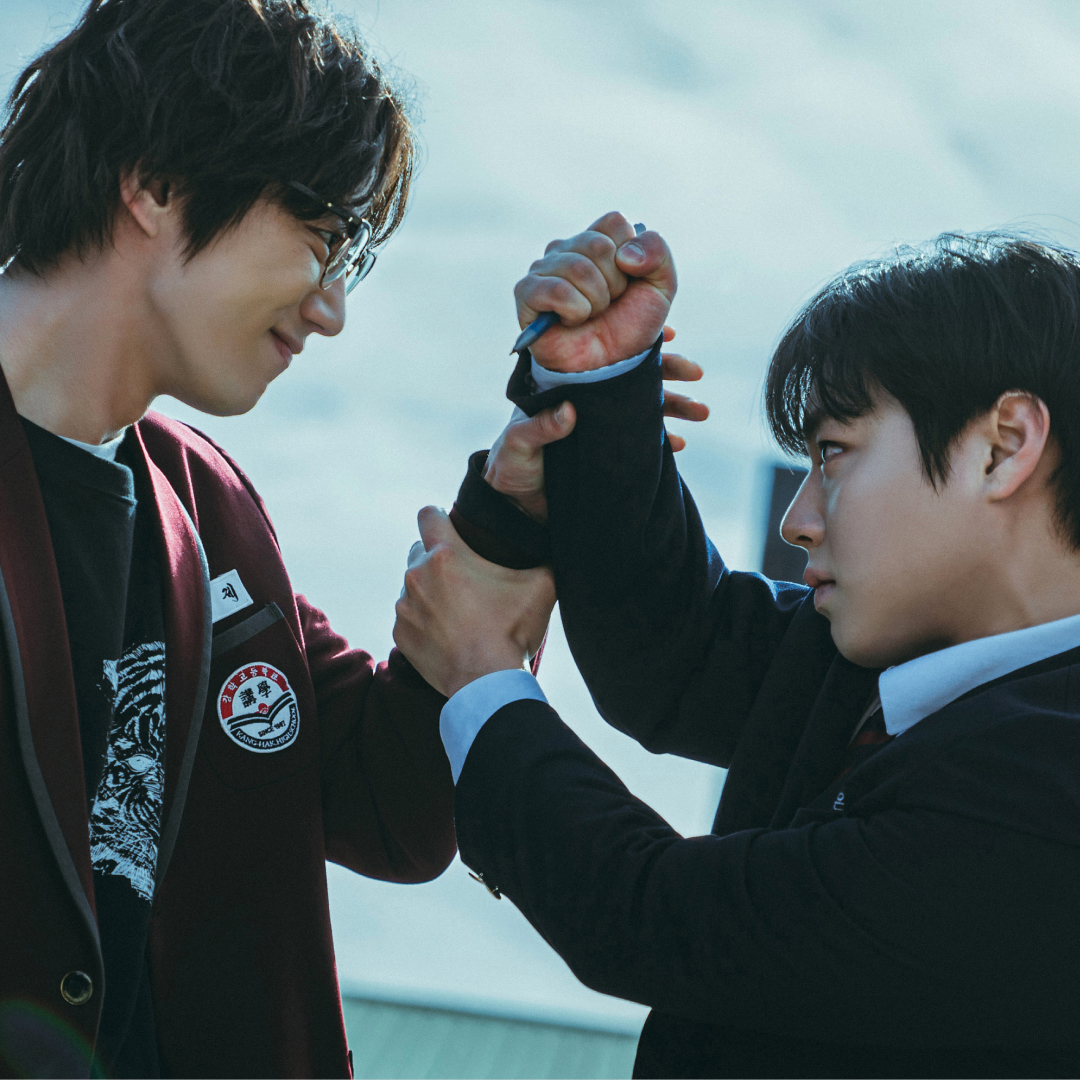 A teen in a red school blazer (Lee Jun-young as Geum Seongje) fights with another teen in a blue blazer (Park Ji-hoon as Yeon Sieun) in Weak Hero Class 2.