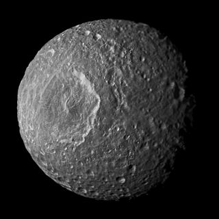 Relatively dark regions below bright crater walls and streaks on some of the walls are seen in this mosaic of Saturn's moon Mimas, created from images taken by NASA's Cassini spacecraft during its closest flyby of the moon on Feb. 13, 2010