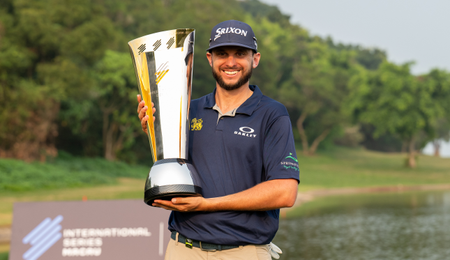 John Catlin poses and holds the International Series Macau trophy