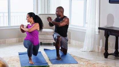 Man and woman doing a 15-minute HIIT workout