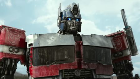 A screenshot of Optimus Prime standing tall in Transformers: Rise of the Beasts.