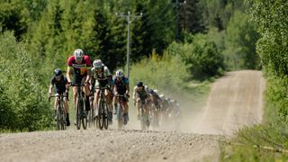 Gravel riders ride as a group along a Finnish gravel road
