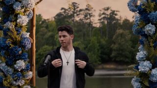 Nick Jonas on the dock preparing to belt out "With Arms Wide Open" in You're Cordially Invited.