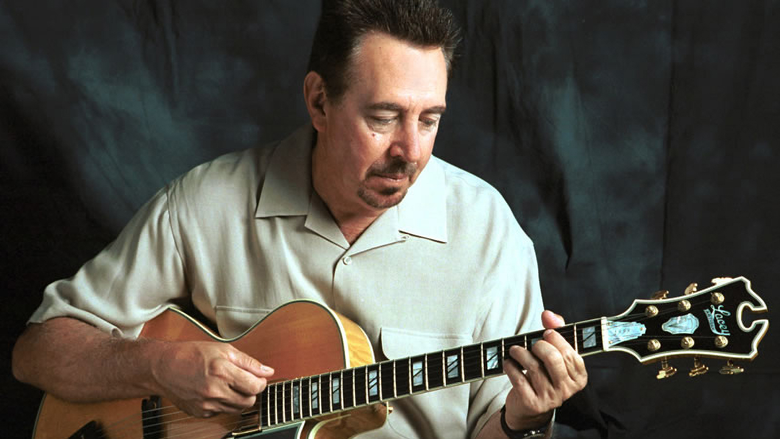 Louie Shelton poses with a guitar
