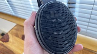 A pair of Sennheiser open-back headphones with the speaker visible through the grille