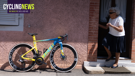 A SpongeBob themed Factor One leans against a house, while an old lady looks curiously toward it
