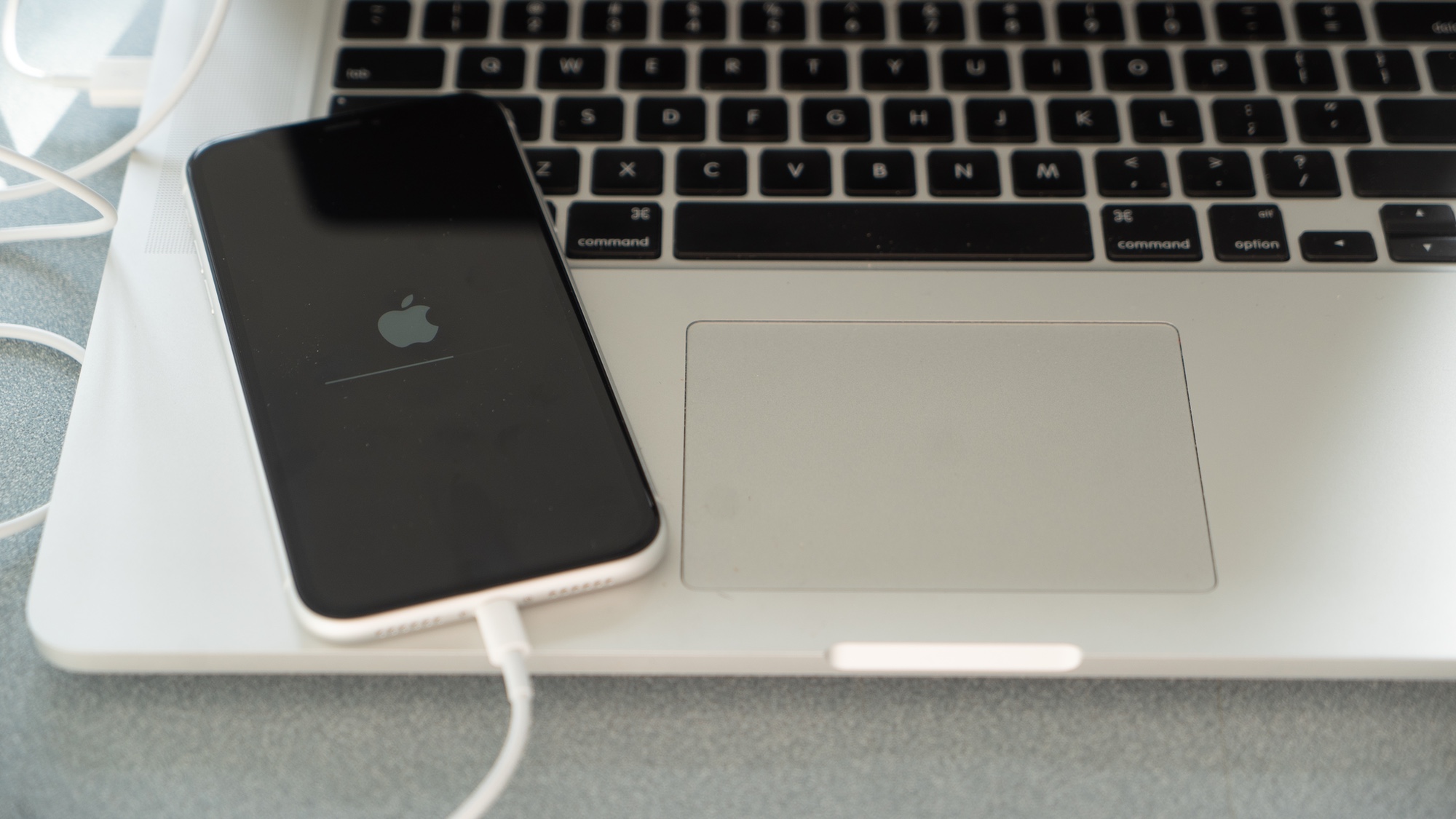 an iPhone plugged into a macbook pro