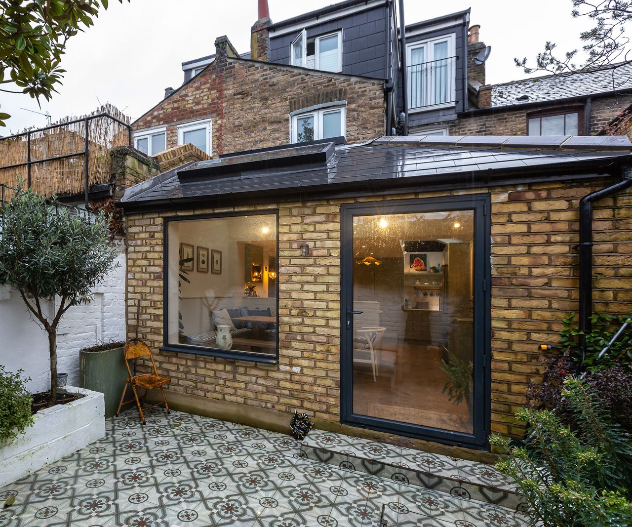 Wraparound kitchen extension built in brick with a large door and window