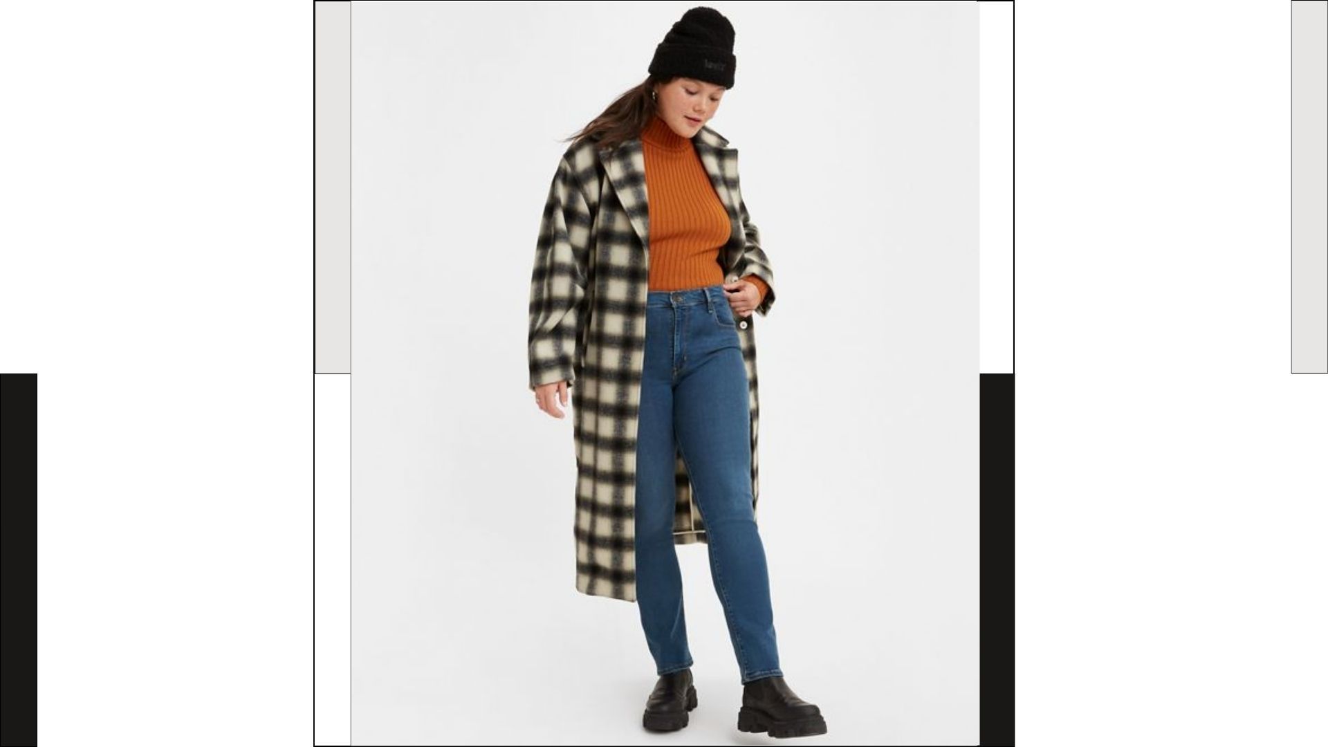 model wearing Levi's 724™ HIGH RISE STRAIGHT JEANS with orange sweater and black and white checkered coat
