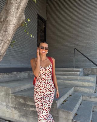 Influencer wears a dress with a cherry print.