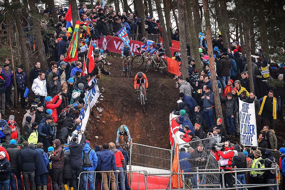 Riders tackle a fast, muddy descent