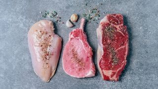 Images shows raw meat on a counter 