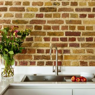 kitchen room with chalk painted brick wall