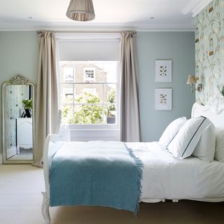 bedroom with blue wall and mirror