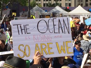 A marcher calls attention to rising sea levels during the March for Science in Los Angeles.