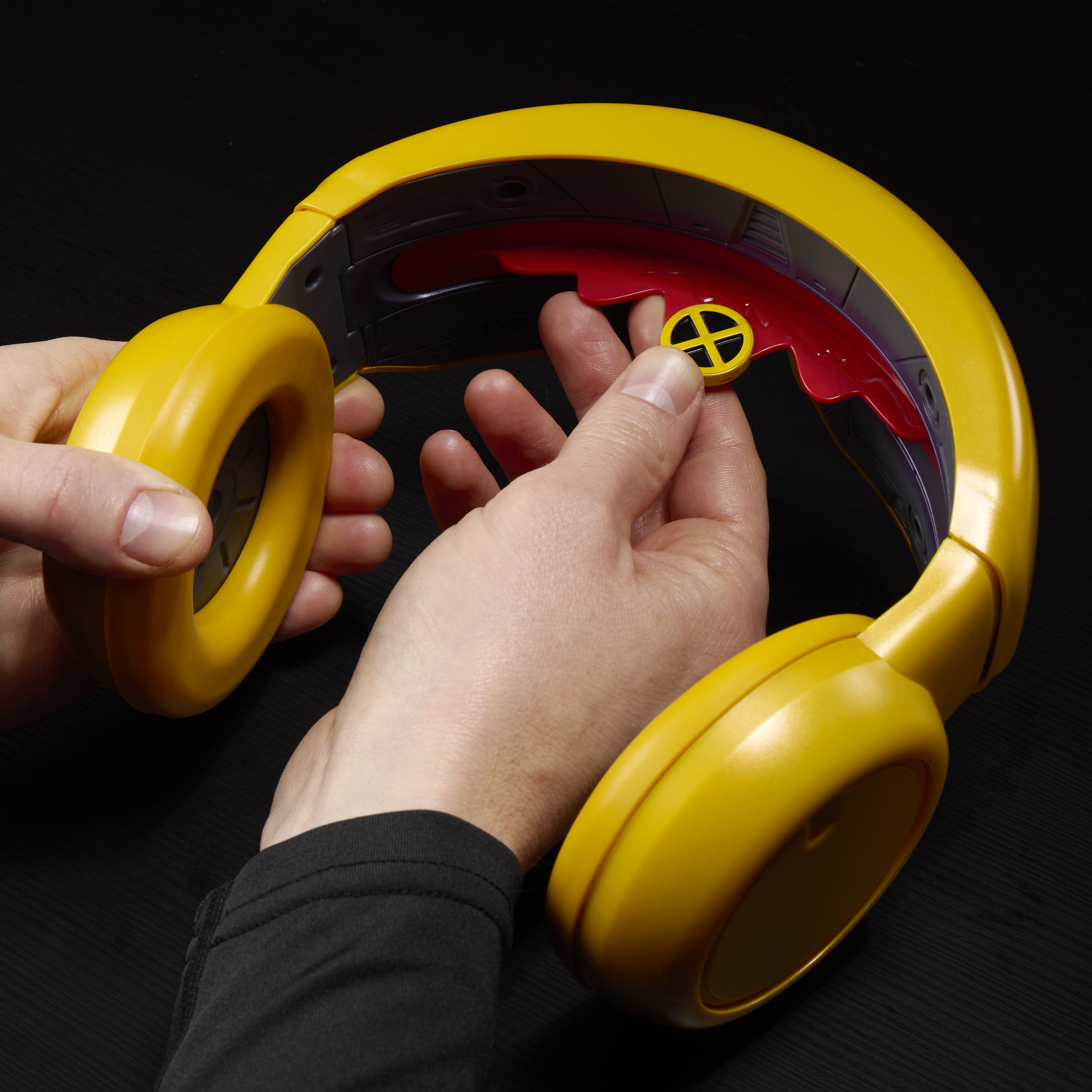 A man holds the X-Men Cyclops Visor against a dark background