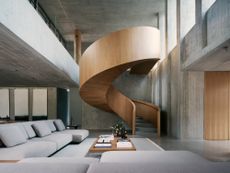 dramatic timber spiral staircase in medellin house made of concrete
